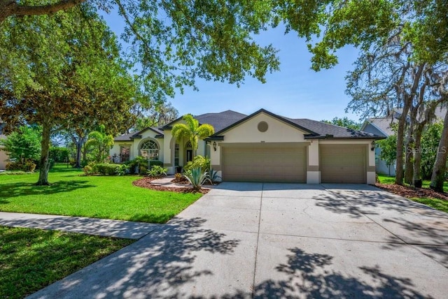 15934 Sorawater Dr, Lithia, FL 33547 - ranch-style home with stucco siding, an attached garage, driveway, and a front yard
