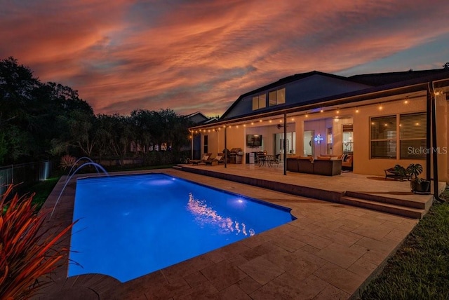 15934 Sorawater Dr, Lithia, FL 33547 - pool at dusk featuring a patio area, outdoor lounge area, and a fenced backyard