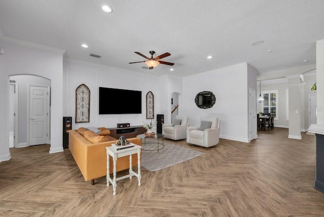15934 Sorawater Dr, Lithia, FL 33547 - living room with arched walkways, ceiling fan, recessed lighting, a textured ceiling, and crown molding