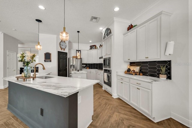 15934 Sorawater Dr, Lithia, FL 33547 - kitchen with a spacious island, stainless steel appliances, tasteful backsplash, white cabinets, and hanging light fixtures