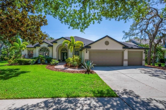 15934 Sorawater Dr, Lithia, FL 33547 - single story home with stucco siding, an attached garage, a front yard, and driveway