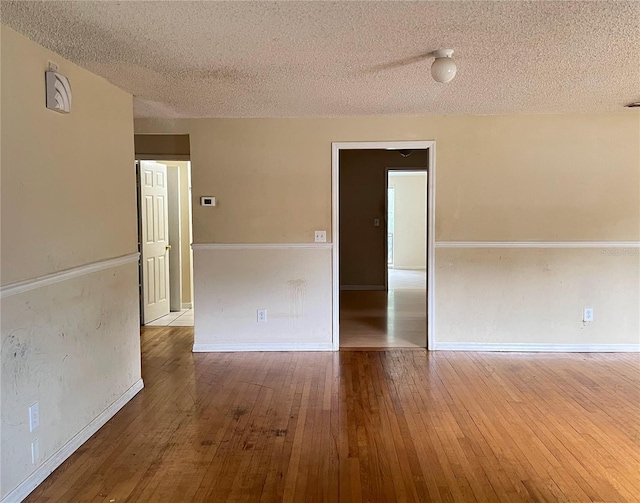 403 E Carolina Ave, Plant City, FL 33563 - unfurnished room featuring a textured ceiling, hardwood / wood-style floors, and baseboards