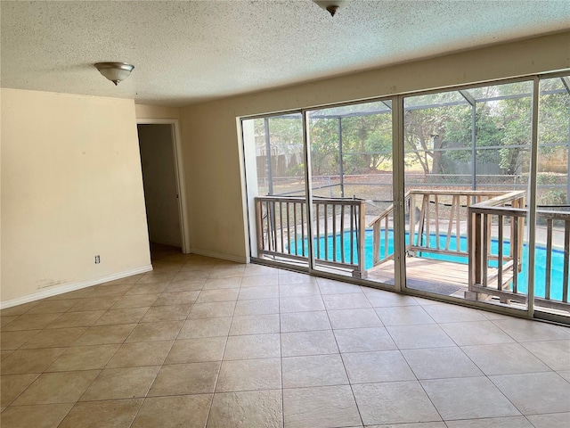 403 E Carolina Ave, Plant City, FL 33563 - tiled spare room with a textured ceiling and baseboards