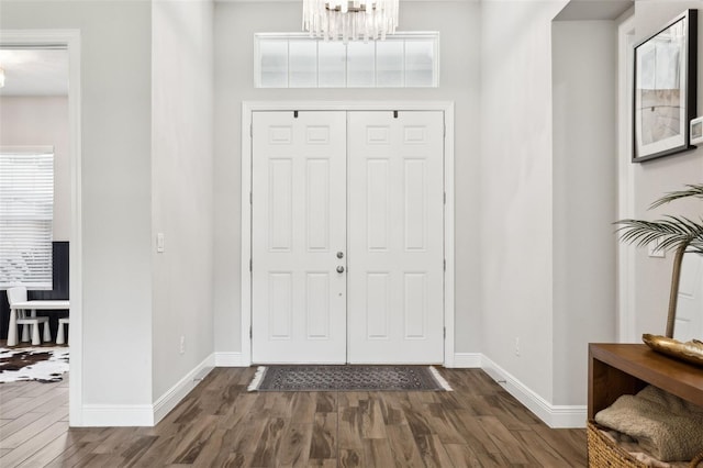 5314 Alafia Falls Dr, Lithia, FL 33547 - foyer entrance with a chandelier, dark wood-style flooring, and baseboards