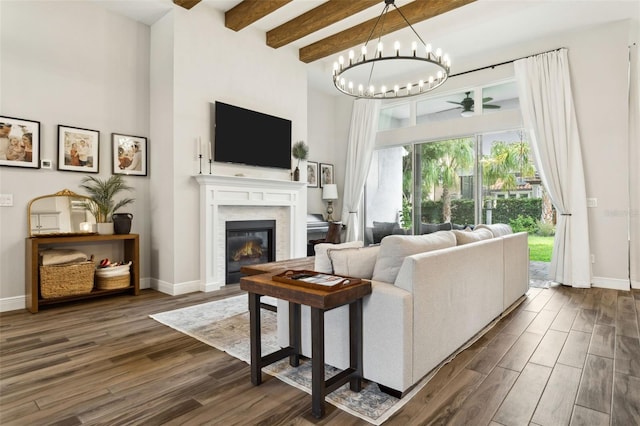 5314 Alafia Falls Dr, Lithia, FL 33547 - living room featuring dark wood finished floors, a towering ceiling, beamed ceiling, a glass covered fireplace, and a ceiling fan