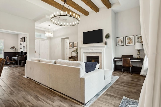5314 Alafia Falls Dr, Lithia, FL 33547 - living room with a chandelier, a desk, a glass covered fireplace, wood finished floors, and beam ceiling