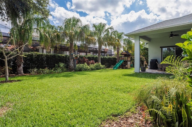 5314 Alafia Falls Dr, Lithia, FL 33547 - view of grassy yard featuring a playground and ceiling fan