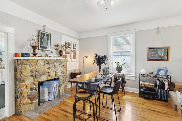 1206 E Frierson Ave Unit B, Tampa, FL 33603 - dining space with wood finished floors and a stone fireplace