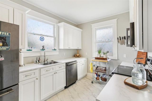 1206 E Frierson Ave Unit B, Tampa, FL 33603 - kitchen with appliances with stainless steel finishes, a sink, light countertops, light marble finish flooring, and ornamental molding