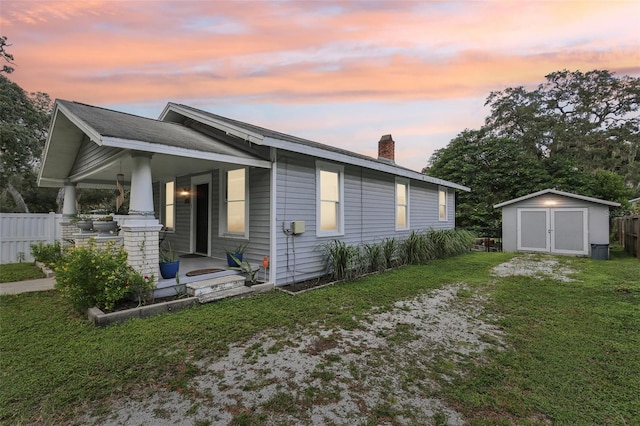 1206 E Frierson Ave Unit B, Tampa, FL 33603 - property exterior at dusk with a chimney and covered porch