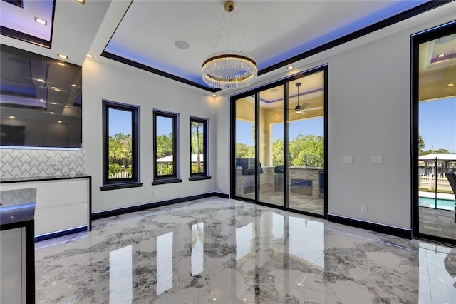 6522 Simone Shores Cir, Apollo Beach, FL 33572 - unfurnished room with marble tiled flooring, healthy amount of natural light, a chandelier, and baseboards