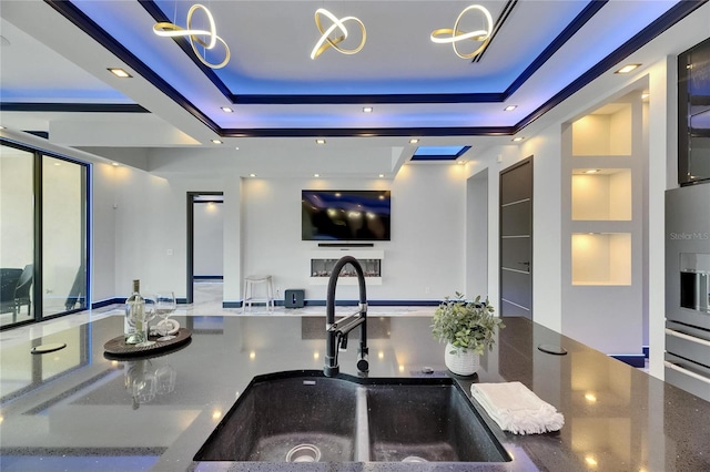 6522 Simone Shores Cir, Apollo Beach, FL 33572 - kitchen featuring a sink, a raised ceiling, open floor plan, and recessed lighting