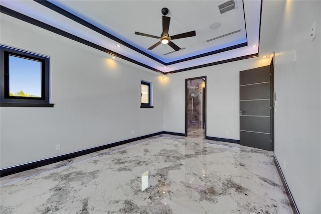 6522 Simone Shores Cir, Apollo Beach, FL 33572 - spare room with ceiling fan, baseboards, a raised ceiling, and marble tiled floors
