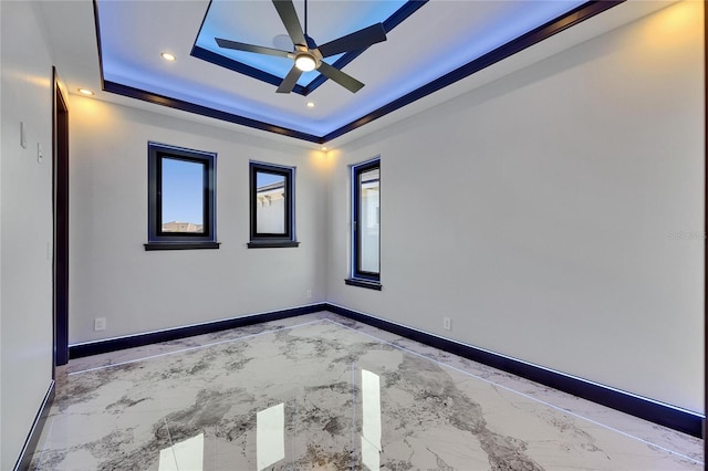 6522 Simone Shores Cir, Apollo Beach, FL 33572 - empty room with light marble finish flooring, a tray ceiling, healthy amount of natural light, baseboards, and recessed lighting