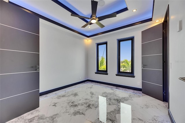 6522 Simone Shores Cir, Apollo Beach, FL 33572 - unfurnished bedroom featuring a tray ceiling, recessed lighting, a ceiling fan, marble finish floors, and baseboards