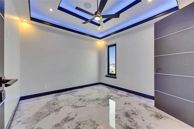 6522 Simone Shores Cir, Apollo Beach, FL 33572 - empty room featuring ceiling fan, a tray ceiling, marble tiled flooring, recessed lighting, and baseboards