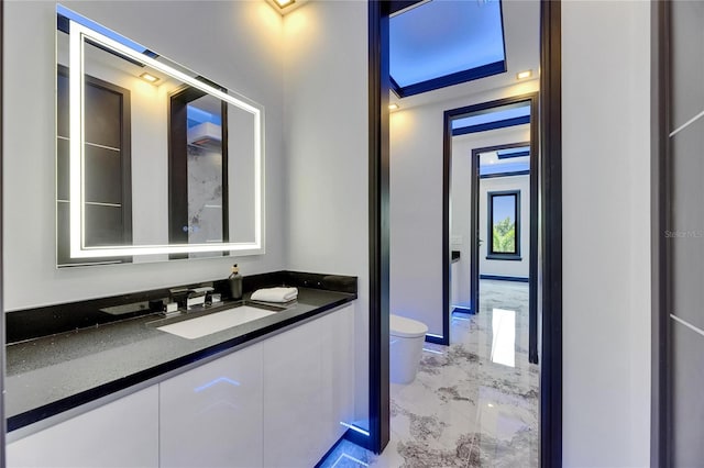 6522 Simone Shores Cir, Apollo Beach, FL 33572 - bathroom featuring toilet, marble tiled floors, and vanity