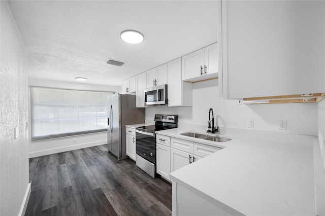 5109 Horton Rd, Plant City, FL 33567 - kitchen featuring stainless steel appliances, a sink, white cabinetry, light countertops, and a textured ceiling