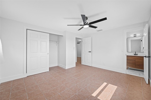 5109 Horton Rd, Plant City, FL 33567 - unfurnished bedroom featuring a closet, light tile patterned floors, connected bathroom, and ceiling fan