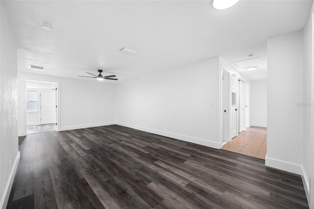 5109 Horton Rd, Plant City, FL 33567 - unfurnished living room with dark wood finished floors, ceiling fan, baseboards, and attic access