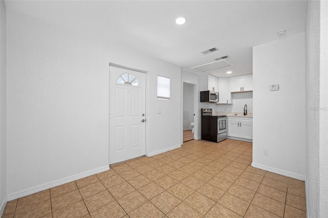 5109 Horton Rd, Plant City, FL 33567 - kitchen with appliances with stainless steel finishes, light countertops, white cabinetry, baseboards, and recessed lighting