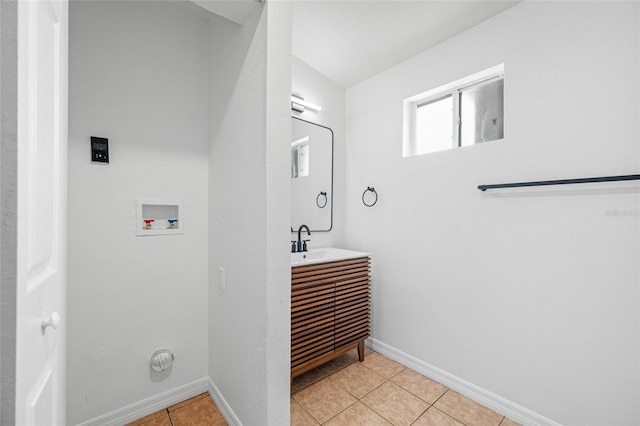 5109 Horton Rd, Plant City, FL 33567 - washroom with washer hookup, a sink, light tile patterned floors, and baseboards