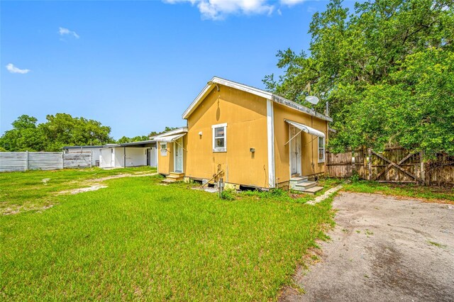 5109 Horton Rd, Plant City, FL 33567 - back of house featuring entry steps and a gate