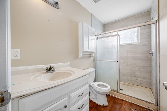 5109 Horton Rd, Plant City, FL 33567 - full bath with toilet, a shower stall, vanity, and wood finished floors