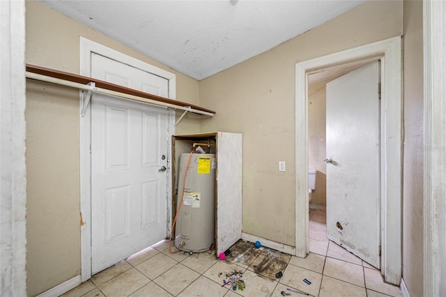 5109 Horton Rd, Plant City, FL 33567 - washroom with water heater, light tile patterned flooring, and baseboards