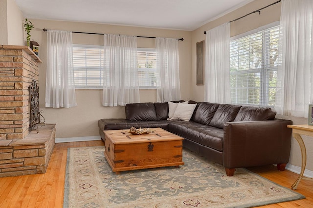 6114 7th Ave S, Gulfport, FL 33707 - living area featuring hardwood / wood-style flooring, plenty of natural light, and baseboards