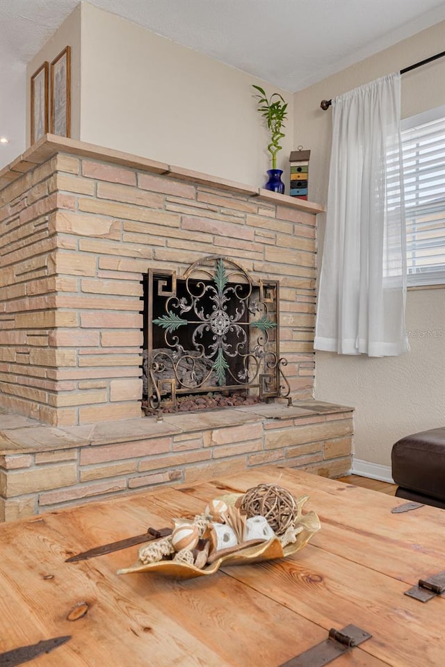 6114 7th Ave S, Gulfport, FL 33707 - living room with a fireplace with raised hearth, baseboards, and wood finished floors