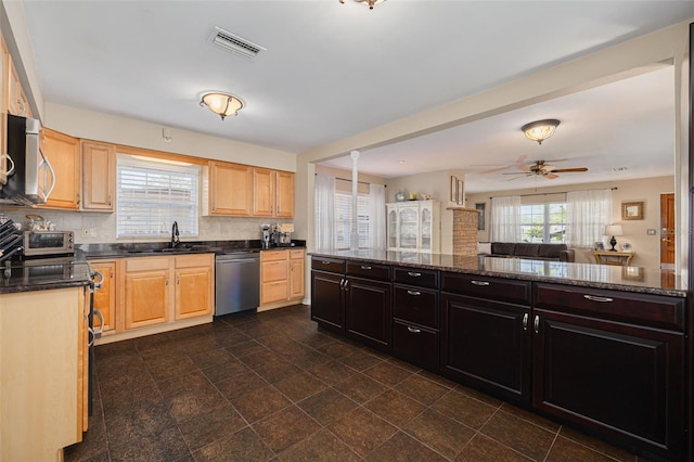 6114 7th Ave S, Gulfport, FL 33707 - kitchen with stainless steel appliances, a sink, tasteful backsplash, light brown cabinetry, and a ceiling fan
