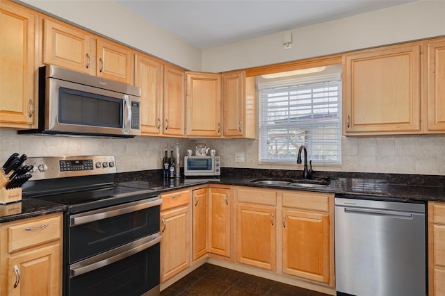 6114 7th Ave S, Gulfport, FL 33707 - kitchen with appliances with stainless steel finishes, a sink, decorative backsplash, and light brown cabinetry