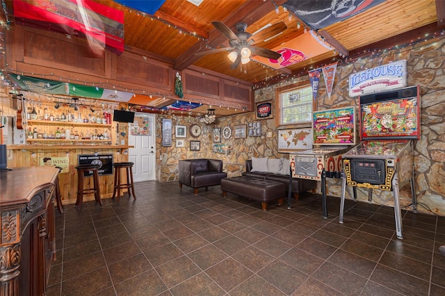 6114 7th Ave S, Gulfport, FL 33707 - sitting room featuring wooden ceiling, a ceiling fan, a bar, a wood stove, and tile patterned flooring