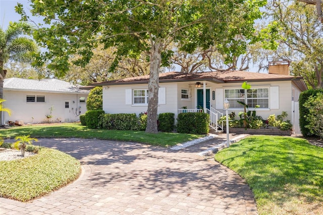 6114 7th Ave S, Gulfport, FL 33707 - ranch-style house featuring ceiling fan, a front yard, and a chimney