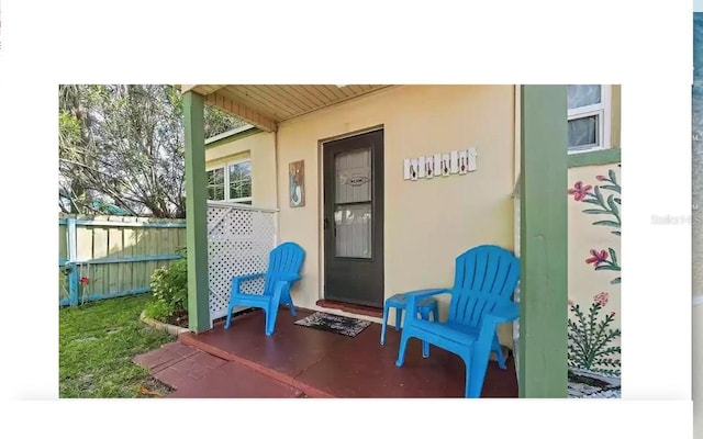 14141 Gulf Blvd Unit 5, Saint Petersburg, FL 33708 - view of exterior entry featuring stucco siding and a porch