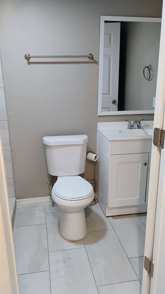 6434 Old Main St, New Port Richey, FL 34653 - bathroom featuring toilet, vanity, and baseboards