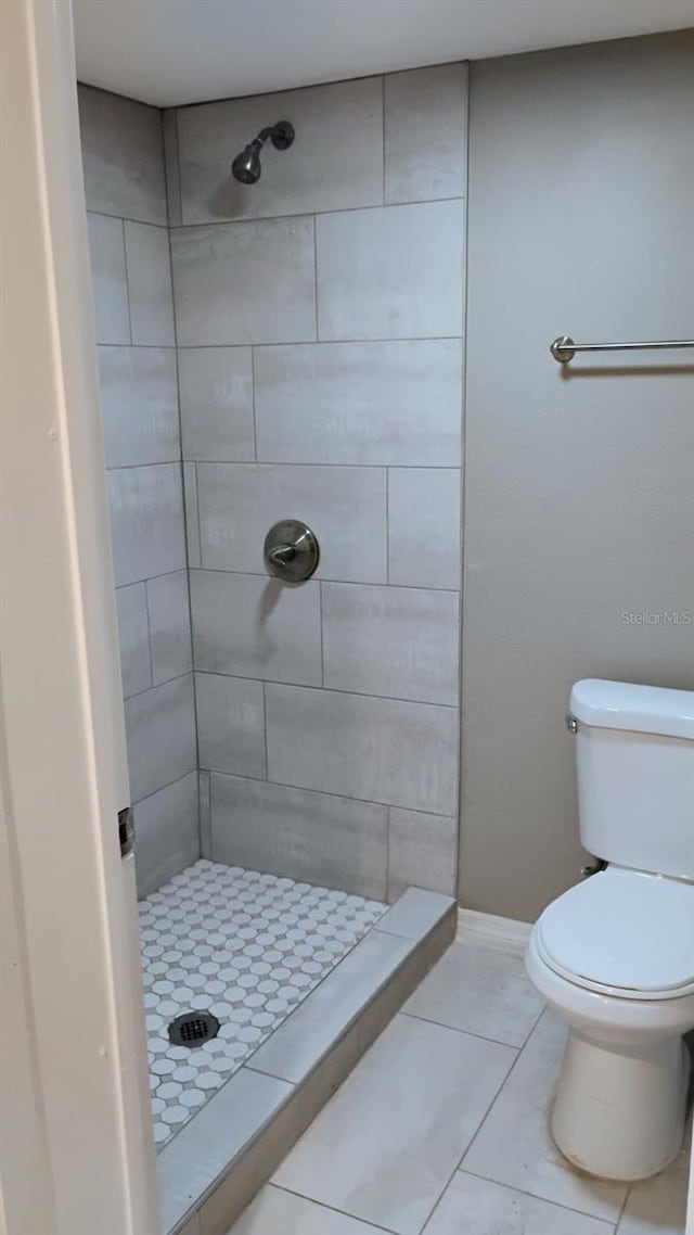 6434 Old Main St, New Port Richey, FL 34653 - bathroom featuring a shower stall, toilet, tile patterned floors, and baseboards