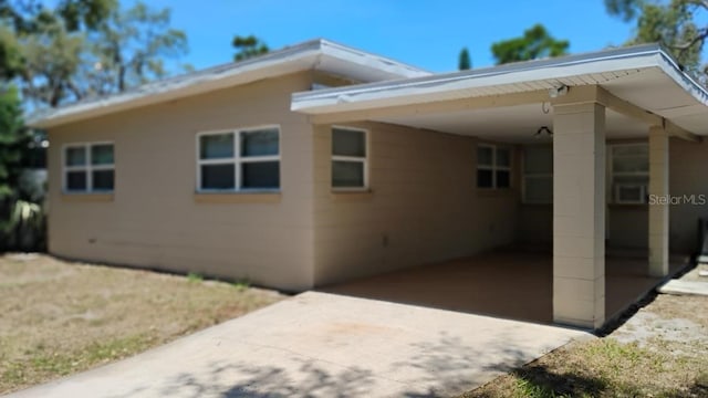 6434 Old Main St, New Port Richey, FL 34653 - view of side of property featuring an attached carport and concrete driveway