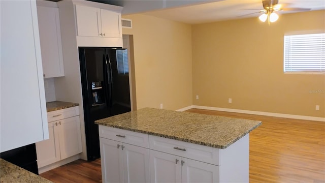6434 Old Main St, New Port Richey, FL 34653 - kitchen featuring black fridge with ice dispenser, light wood-style floors, ceiling fan, baseboards, and white cabinetry