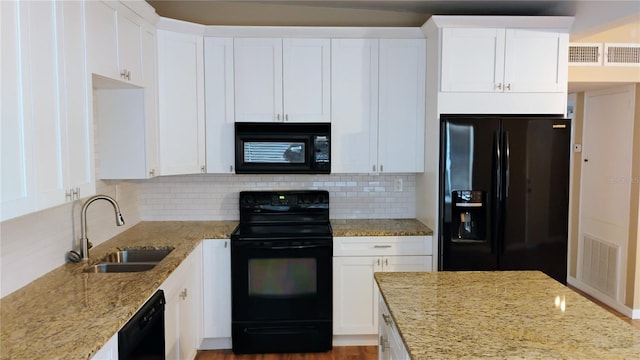 6434 Old Main St, New Port Richey, FL 34653 - kitchen with black appliances, a sink, light stone countertops, and decorative backsplash