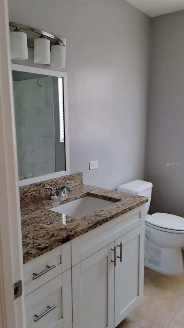 6434 Old Main St, New Port Richey, FL 34653 - bathroom with vanity, toilet, and tile patterned flooring