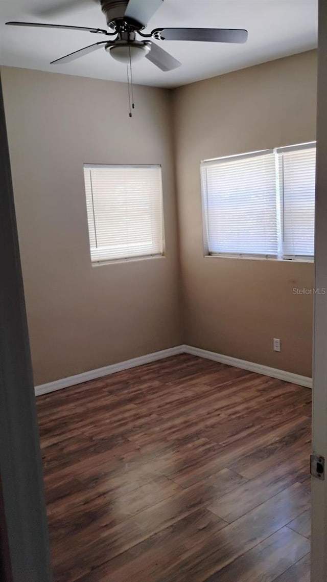 6434 Old Main St, New Port Richey, FL 34653 - spare room with a ceiling fan, healthy amount of natural light, wood finished floors, and baseboards