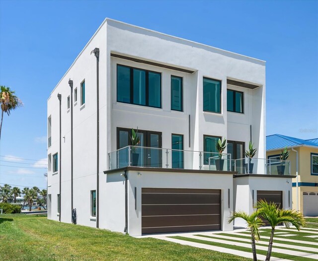 16047 Redington Dr, Redington Beach, FL 33708 - view of front of home featuring stucco siding, a garage, and a front yard