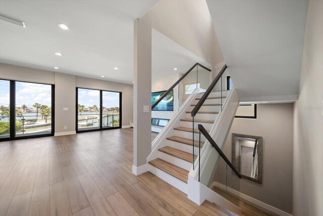 16047 Redington Dr, Redington Beach, FL 33708 - stairway with baseboards, wood finished floors, and recessed lighting