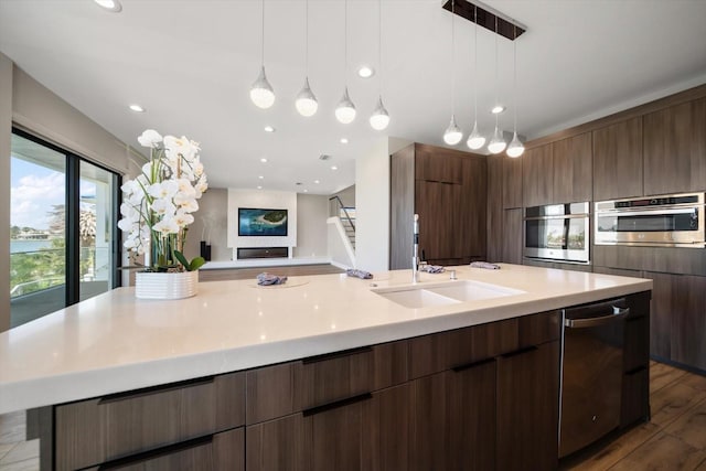 16047 Redington Dr, Redington Beach, FL 33708 - kitchen with stainless steel appliances, light countertops, modern cabinets, a spacious island, and wood finished floors