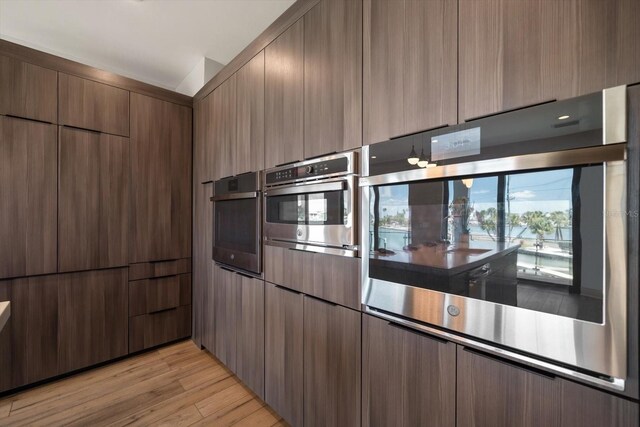 16047 Redington Dr, Redington Beach, FL 33708 - kitchen featuring oven, light wood-style floors, and modern cabinets