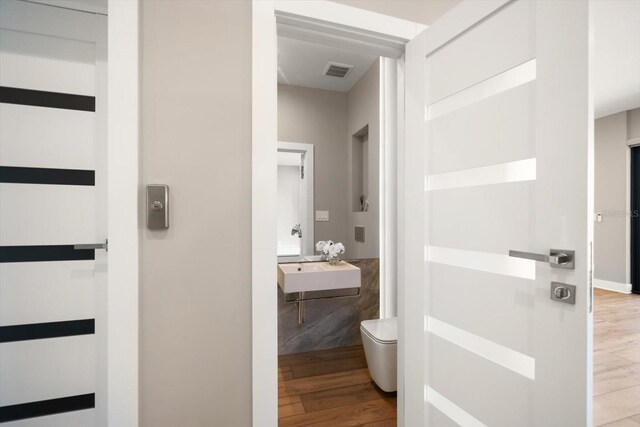 16047 Redington Dr, Redington Beach, FL 33708 - hall featuring wood finished floors and a sink