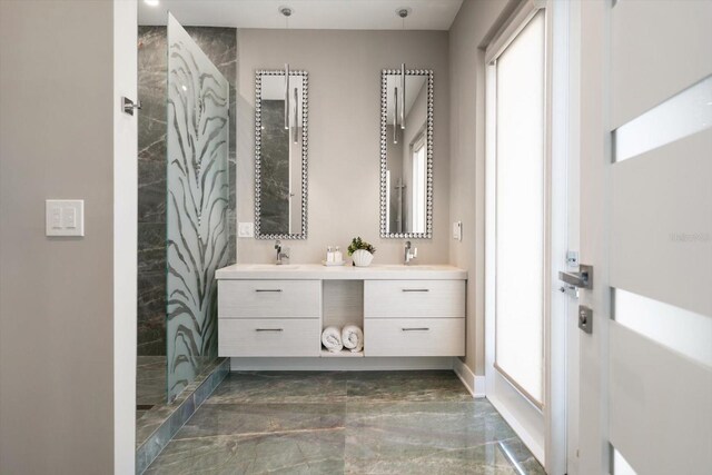 16047 Redington Dr, Redington Beach, FL 33708 - full bathroom with marble tiled floors, double vanity, plenty of natural light, and tiled shower