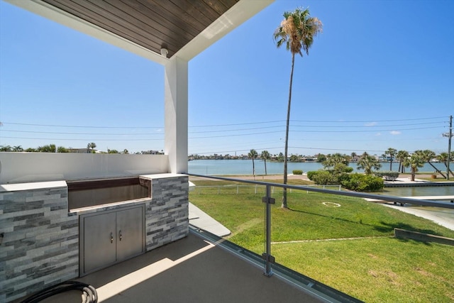 16047 Redington Dr, Redington Beach, FL 33708 - view of patio / terrace featuring exterior kitchen and a water view